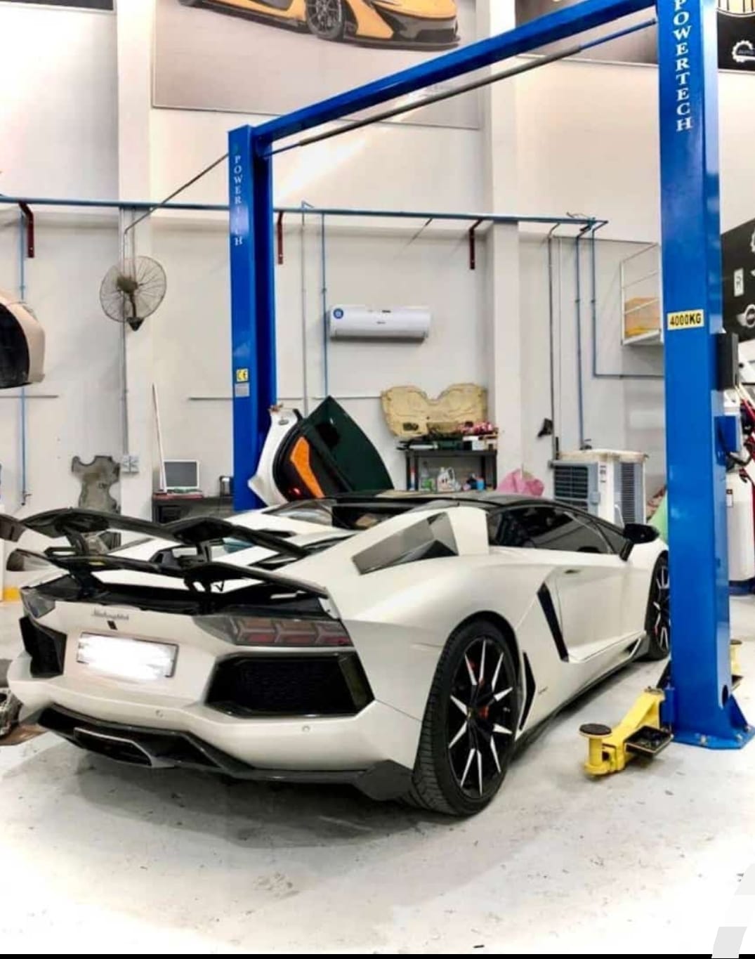 Mobile technician servicing an engine bay with a full tool tray